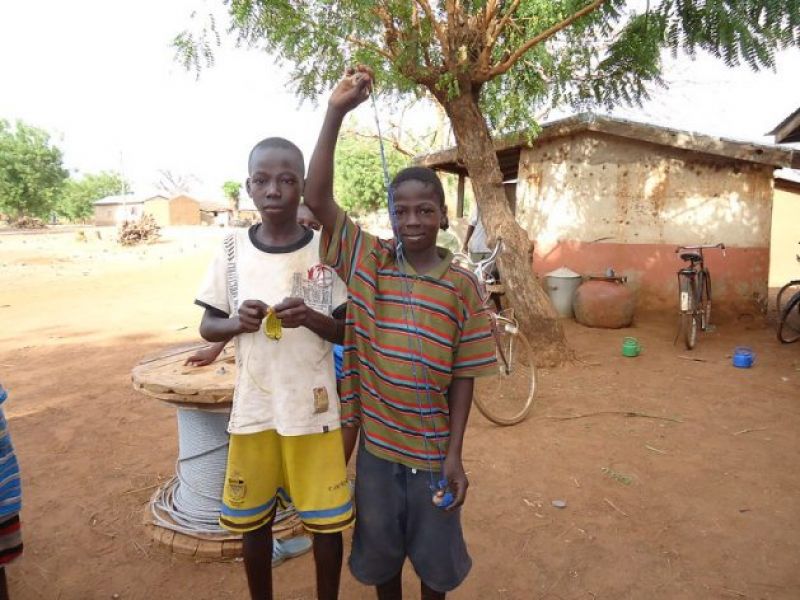 Musah Razark Adams, 13, (r) shows the sling shot that he uses to hit birds with when he works in a local rice field-80199d9077f2541978cc86ffcee367291623383823.jpg